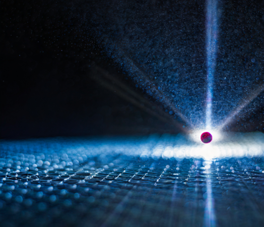 Low energy electron emission from charge exchange of slow highly charged ions with solid surfaces